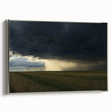 Framed canvas artwork showcasing a serene countryside landscape with vibrant green fields and a clear blue sky. The silver frame adds an elegant touch, perfect for home decor.