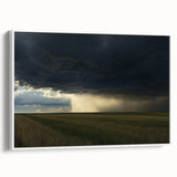 Framed canvas artwork depicting a serene countryside landscape, featuring lush green fields and a blue sky, presented in a white frame for an elegant touch.