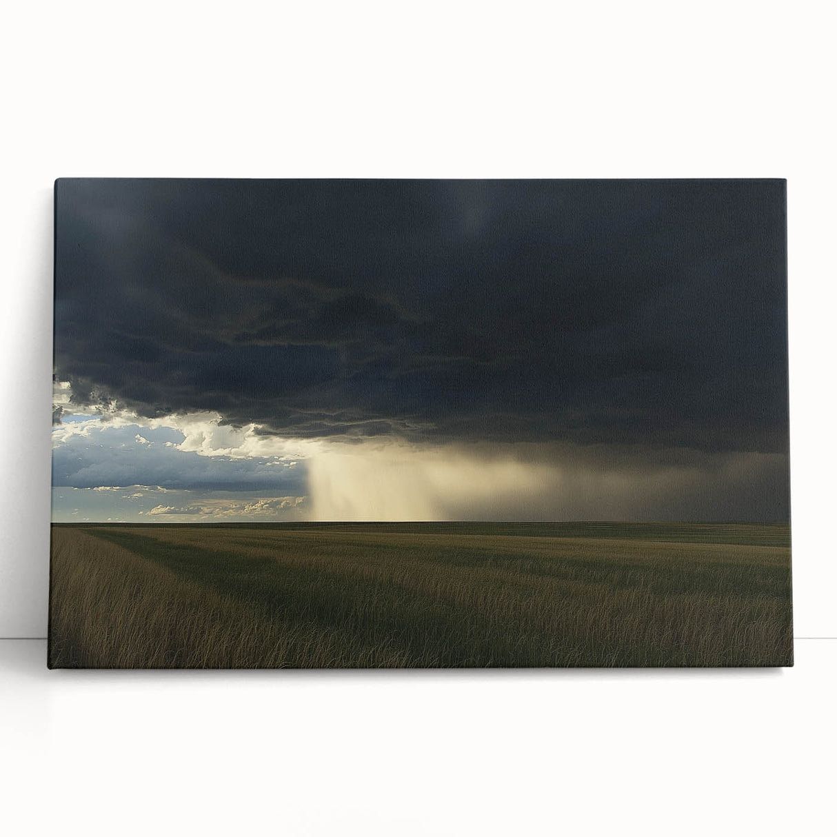 Stretched canvas artwork depicting a serene countryside landscape with rolling hills, vibrant greenery, and a clear blue sky, perfect for home decor.