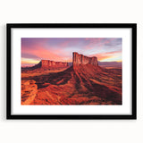 Framed landscape artwork depicting a serene desert scene, featuring warm earth tones and intricate details, presented in a sleek black frame with a white mat. Ideal for home decor enthusiasts seeking a tranquil aesthetic.