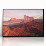 Framed acrylic artwork showcasing a vibrant desert landscape, featuring warm tones of orange and yellow with black framing, ideal for modern home decor.