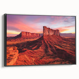 Framed canvas depicting a serene desert landscape with warm hues of orange and yellow, featuring a black frame for a modern touch, ideal for home decor.