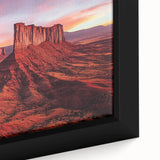 Framed canvas artwork showcasing a desert landscape with vibrant hues of orange and yellow, emphasizing the serene beauty of nature in a close-up view.
