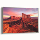 Framed canvas artwork depicting a serene desert landscape, showcasing warm earthy tones and intricate details, accented with a sleek silver frame, perfect for modern decor.