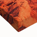 Close-up of a stretched canvas artwork depicting a vibrant desert landscape, showcasing warm hues of orange and yellow, ideal for home decor or art enthusiasts.