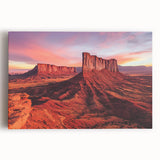 Stretched canvas artwork displaying a vibrant desert landscape with warm hues of orange and yellow, ideal for home decor or artistic inspiration.