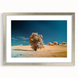 Framed landscape artwork featuring vibrant green fields and a serene blue sky, encased in a sleek silver mat, perfect for modern home decor.