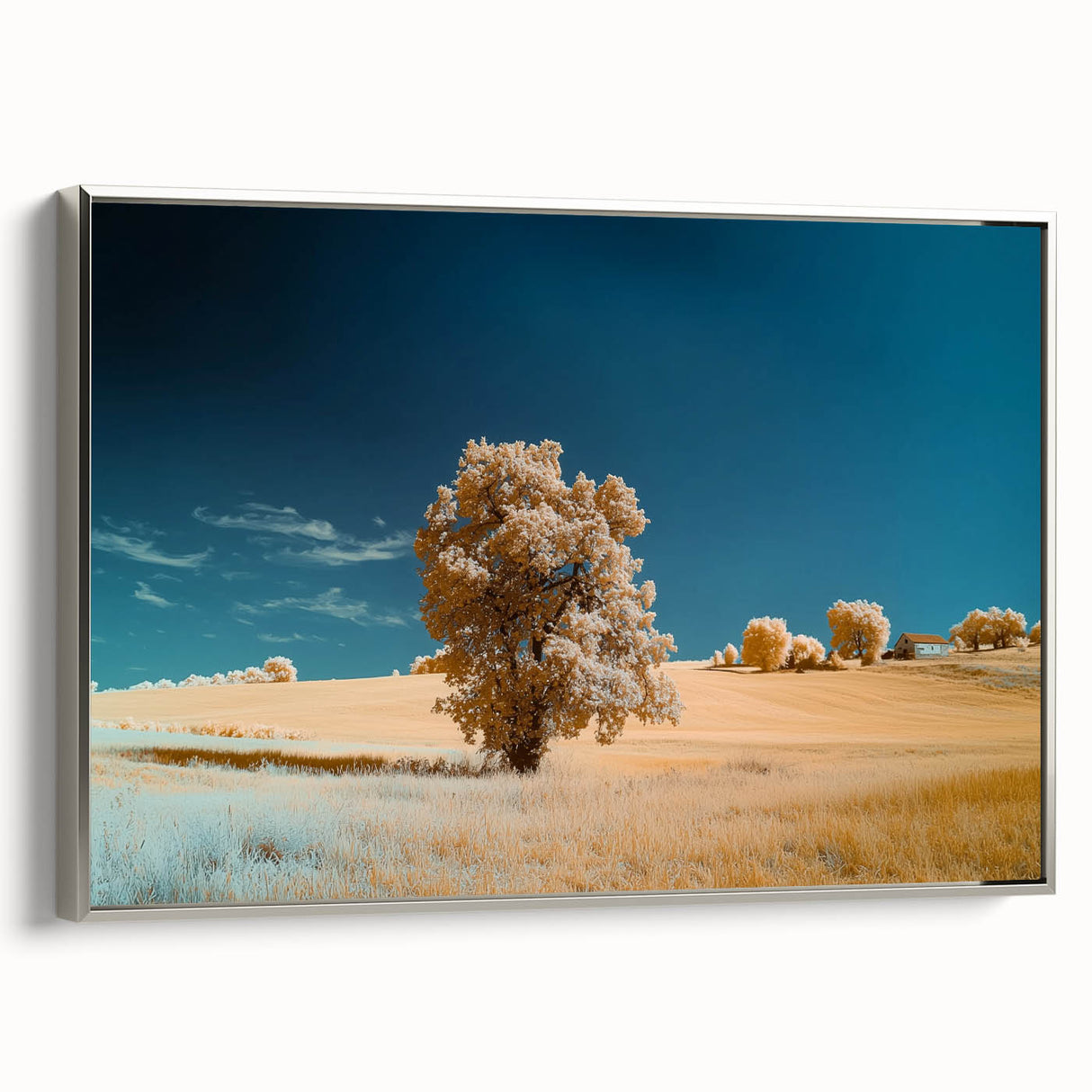 Framed canvas artwork depicting a serene landscape of rolling fields, featuring vibrant greens and golden hues, set in an elegant silver frame, ideal for home decor.