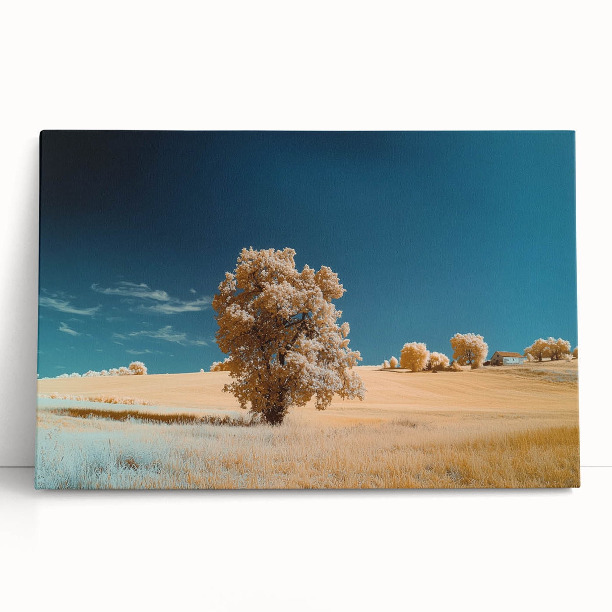 Vibrant landscape canvas print depicting expansive green fields under a clear blue sky, leaning against a white wall, ideal for home decor.
