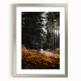 Textured abstract art print in earthy orange and brown tones, framed in silver, ideal for bedroom ambiance.