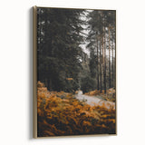 Framed canvas depicting a vintage landscape painting with autumnal trees in gold and black tones.