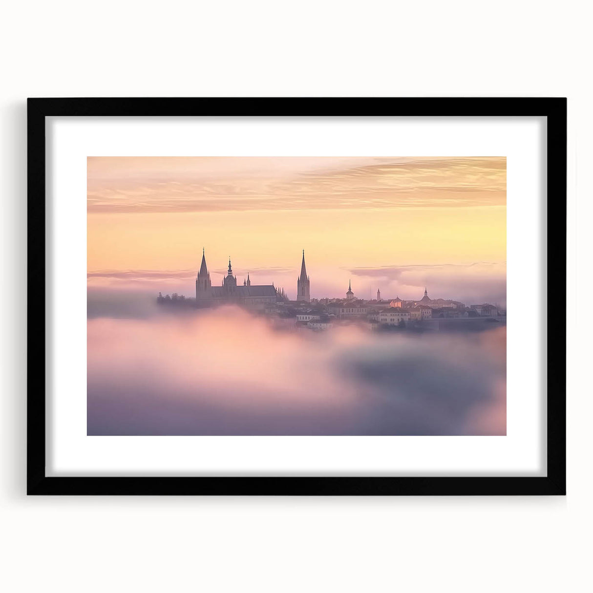 Framed landscape artwork depicting a majestic castle, surrounded by lush greenery, with a sleek black frame and white matting, ideal for home decor.