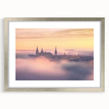 Silver-framed landscape artwork depicting a majestic castle surrounded by lush greenery, featuring a white mat for enhanced presentation, perfect for home decor.