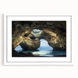 Framed landscape artwork showcasing a serene cave scene with a white mat, designed to enhance home decor. Perfect for adding a touch of nature to any room.