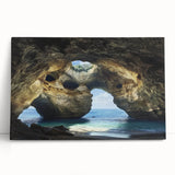 Stretched canvas artwork depicting an abstract landscape with cave-like formations, featuring earthy tones and smooth textures, ideal for modern home decor.