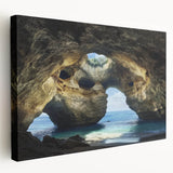 Stretched canvas artwork depicting a vibrant landscape with intricate cave formations, showcasing rich colors and textures, ideal for home decor or art enthusiasts.