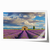 Rolled print showcasing a vibrant landscape design with a rustic barn set against a colorful sky, packaged securely in a protective cardboard tube for safe transport.