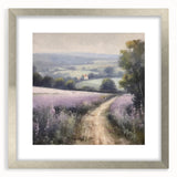 Framed landscape wall art depicting a serene countryside scene with lush greenery and rolling hills, featuring a silver mat and frame, ideal for home decor.