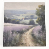 Stretched canvas wall art depicting a serene landscape of rolling green hills and a vibrant blue sky, leaning against a light-colored wall, ideal for home decor.