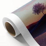Vibrant rolled canvas print showcasing a serene landscape of lush green fields under a bright blue sky, elegantly packaged in a durable cardboard tube for protection.