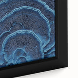 Close-up of textured black wall art featuring colorful floral designs on a framed canvas, ideal for living room decor.