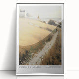 Art deco poster featuring a stylized portrait of Camille in muted pastel shades, framed in white acrylic.