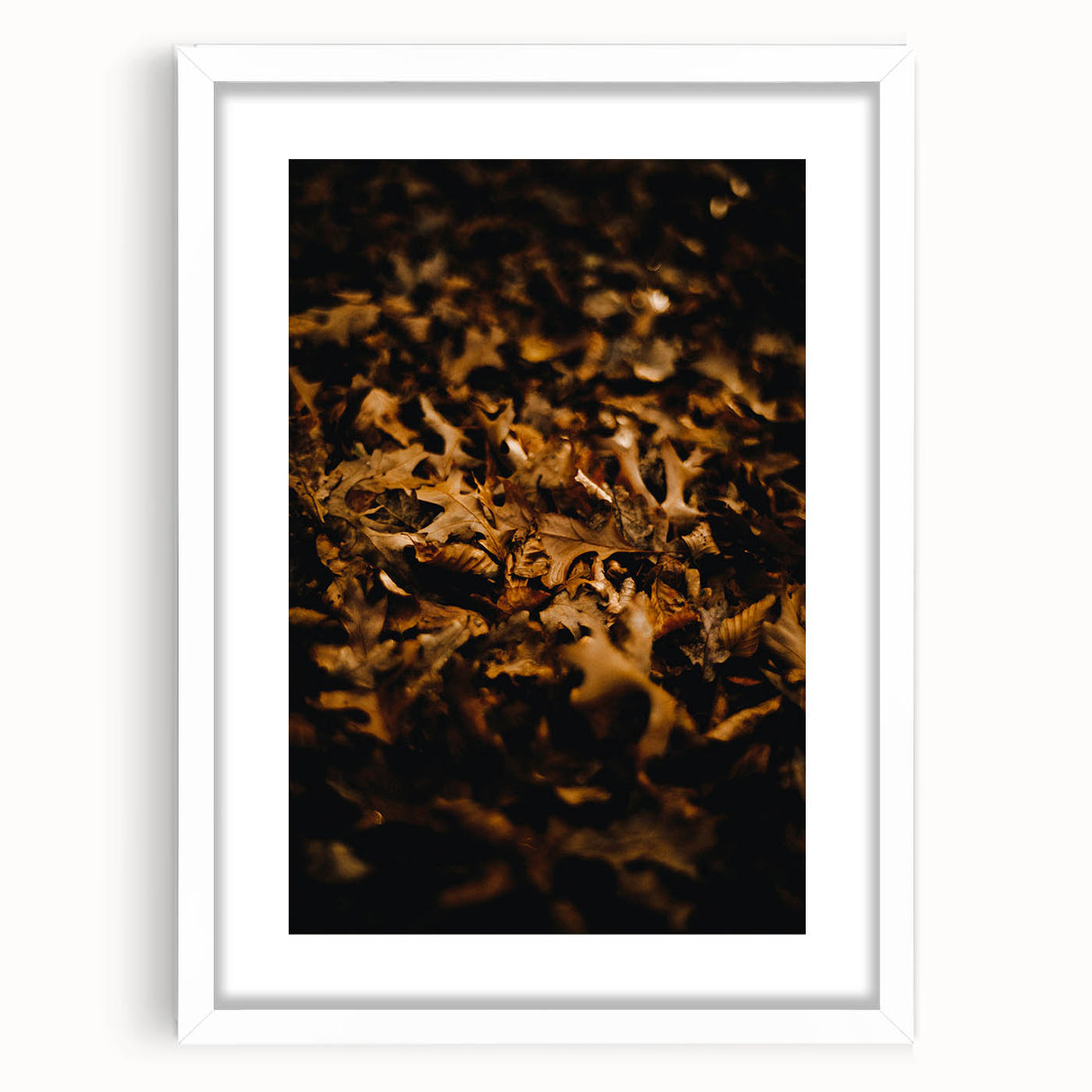 Abstract art print of autumn leaves in orange and red tones on a white framed canvas, ideal for dining room decor.