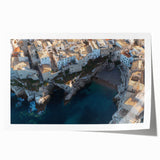 Stunning landscape print showcasing dramatic cliffs under a vibrant sunset, rolled for easy shipping. Perfect for adding a touch of nature to home decor.