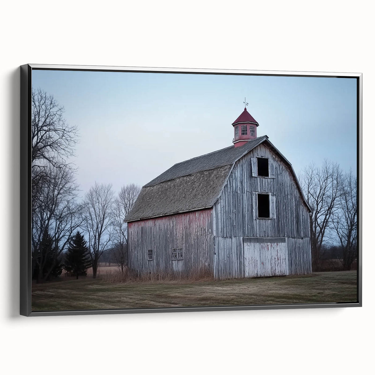 Landscape barn-themed canvas print displayed in a black frame, showcasing rustic natural tones and a textured finish, perfect for farmhouse decor.