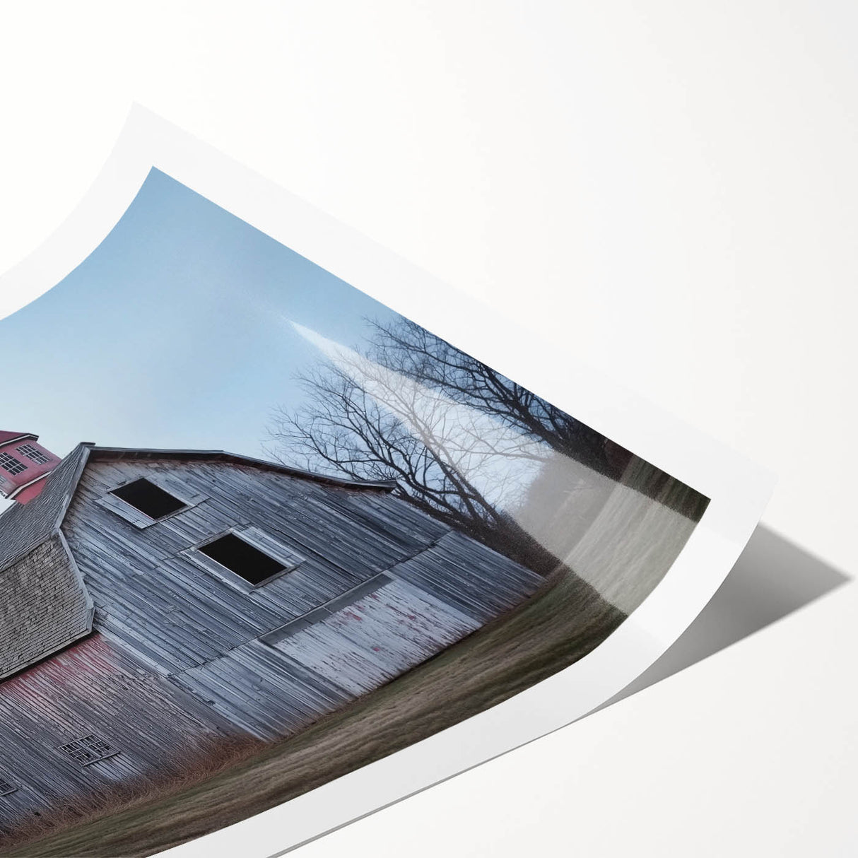 Rolled landscape print of a rustic barn scene, showcasing vibrant colors and detailed texture, securely packaged in a protective cardboard tube for safe delivery.