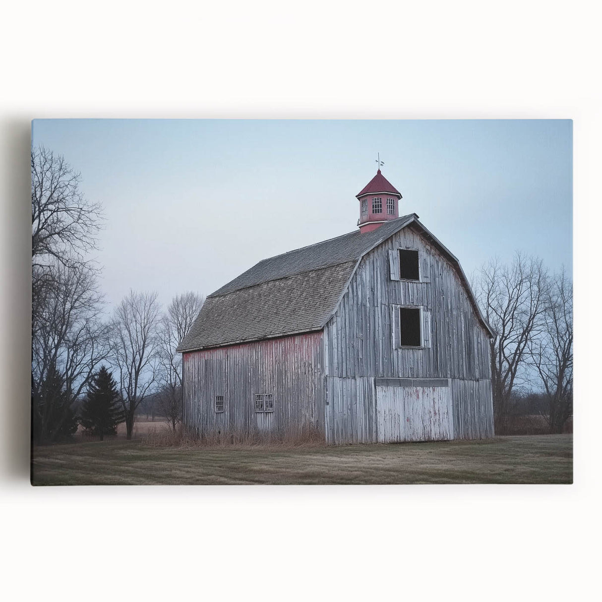 Stretched canvas print showcasing a picturesque landscape of a classic red barn surrounded by lush greenery, ideal for rustic home decor. Perfect for enhancing country-themed interiors and adding a touch of warm charm.