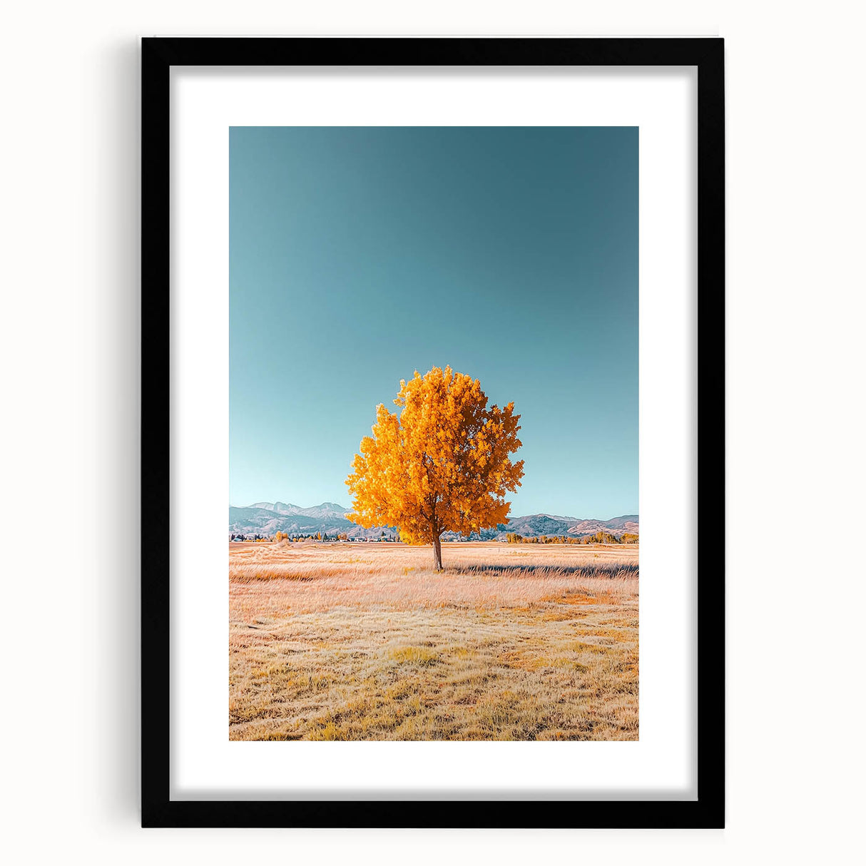 Black-framed landscape art print featuring vibrant fields and lush greenery, set against a neutral mat, enhancing its visual appeal for home decor.