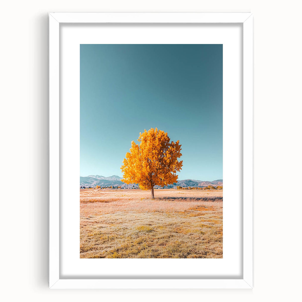 Framed landscape artwork depicting vibrant green fields under a clear blue sky, encased in a clean white mat and sleek frame, perfect for home decor.