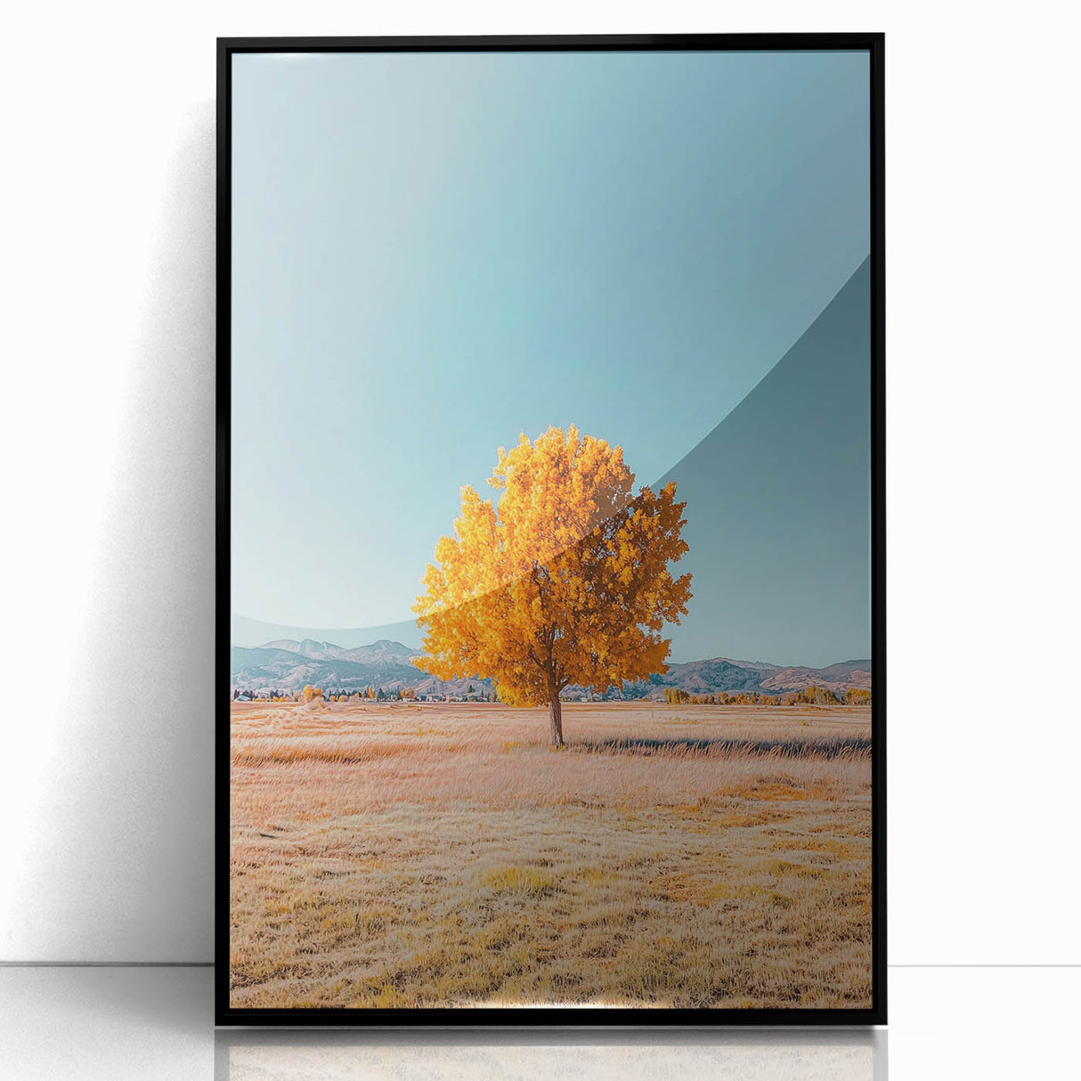 Framed acrylic artwork depicting a serene landscape field with lush green grass and a vibrant blue sky, set in a sleek black frame, ideal for home decor.