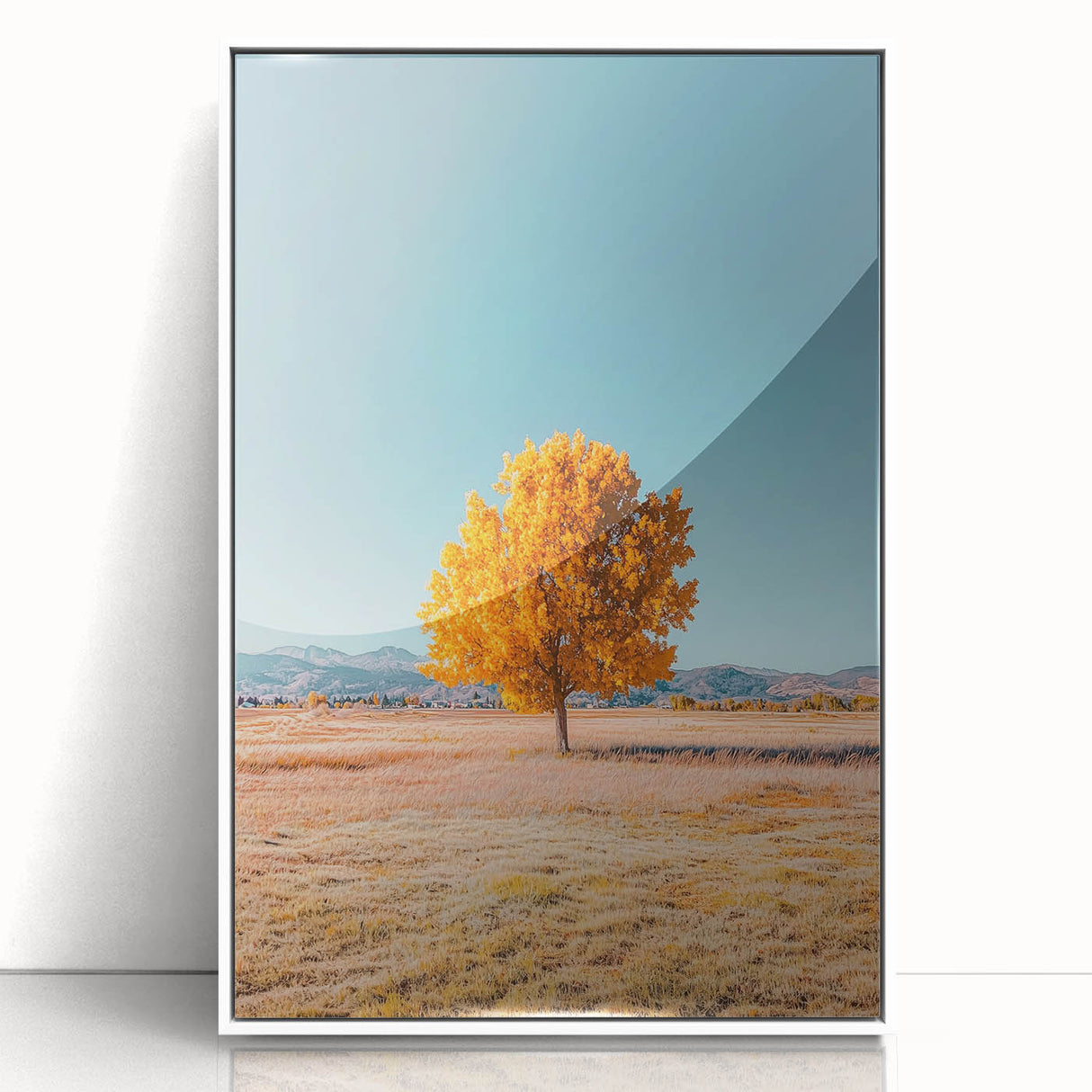 Framed acrylic artwork showcasing vibrant green landscapes with golden fields under a clear blue sky, elegantly presented in a white frame for modern decor.