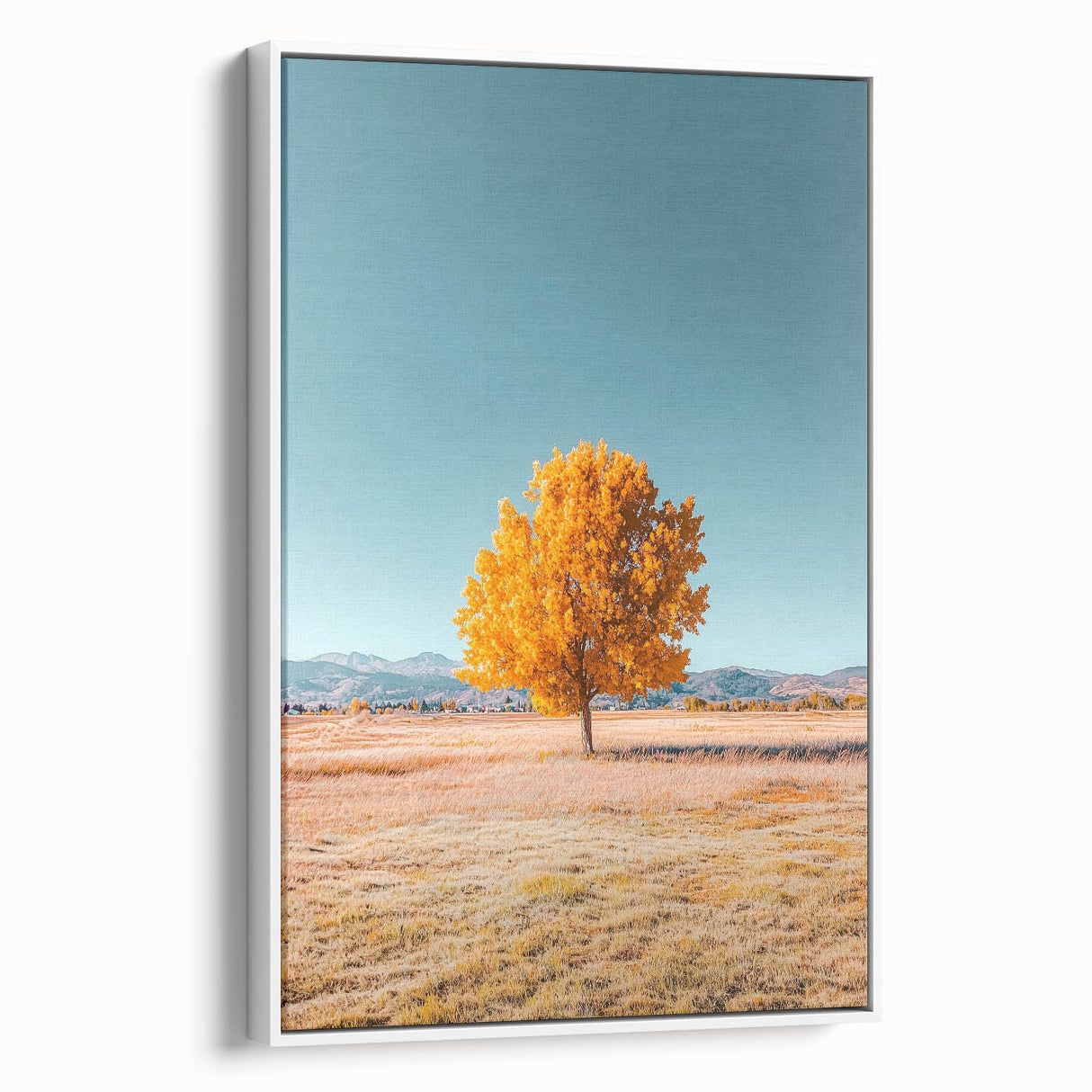 Framed canvas artwork showcasing a serene landscape of rolling fields under a clear blue sky, presented in a white frame for an elegant touch, ideal for home decor.