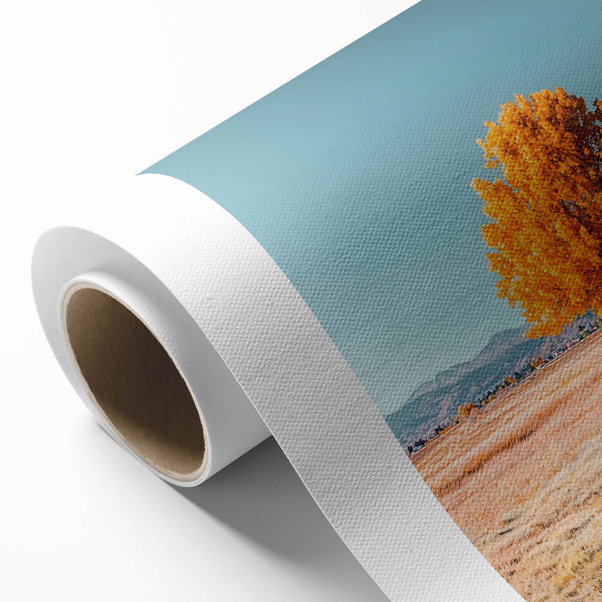 Vibrant rolled canvas artwork showcasing a serene landscape with lush green fields and a clear blue sky, elegantly packaged in a protective cardboard tube.