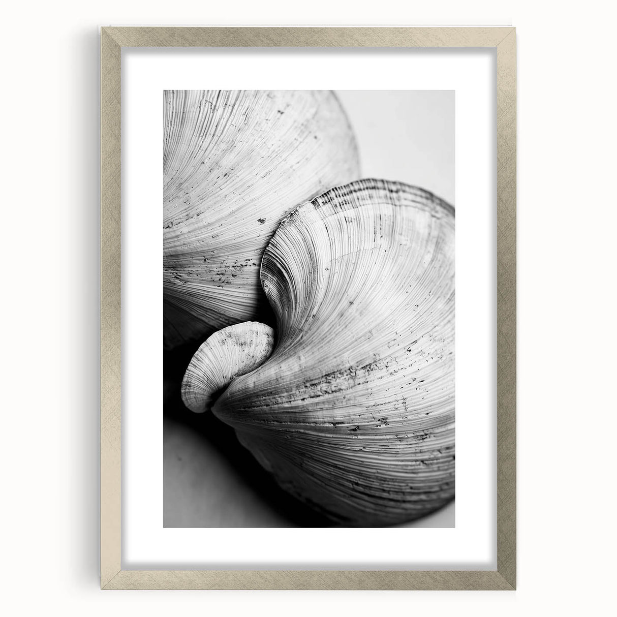Textured abstract art print featuring natural elements in muted earth tones, framed in silver, ideal for bedroom decor.