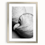 Textured abstract art print featuring natural elements in muted earth tones, framed in silver, ideal for bedroom decor.