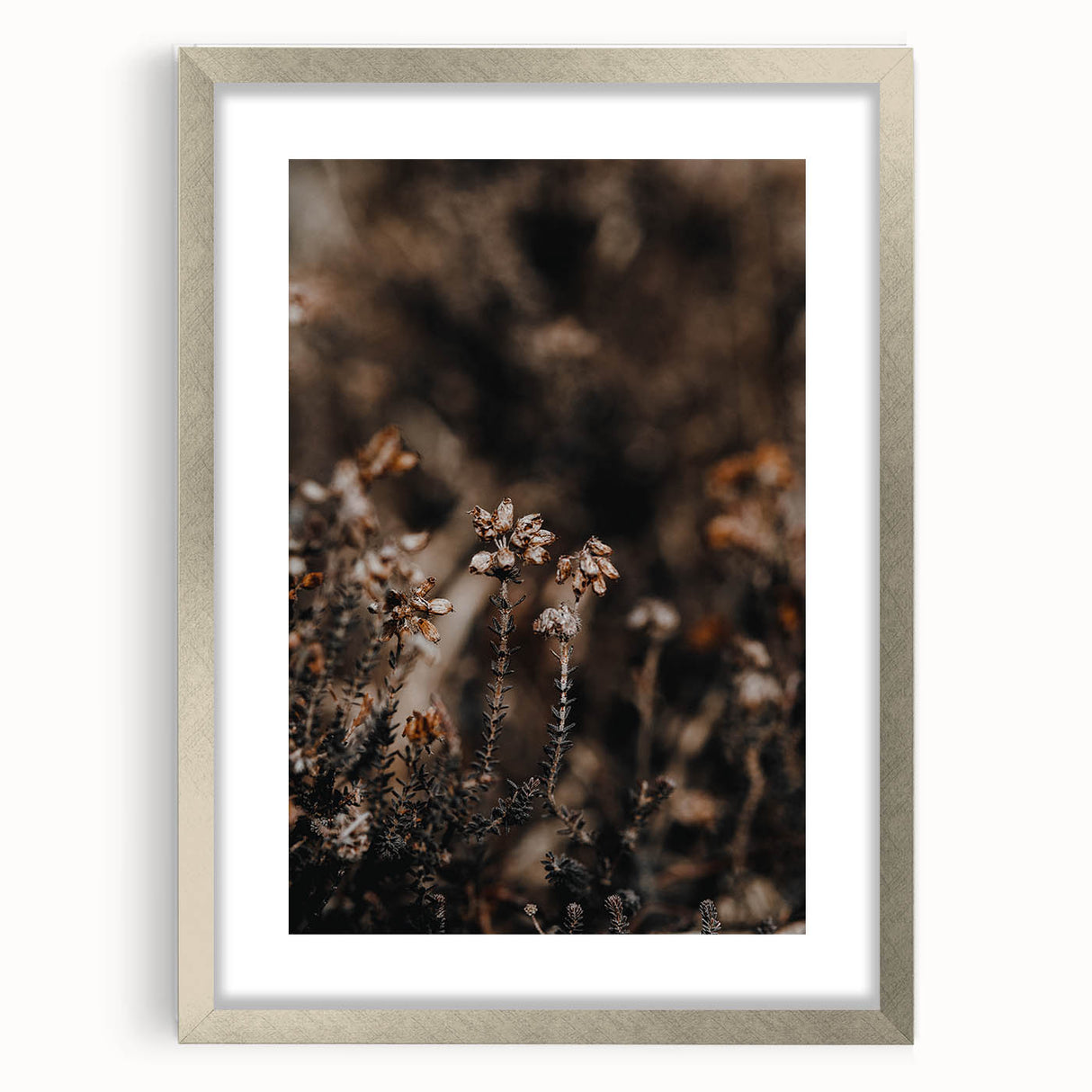 Textured abstract art print in warm autumn hues on a silver-framed canvas, ideal for bedroom wall decor.