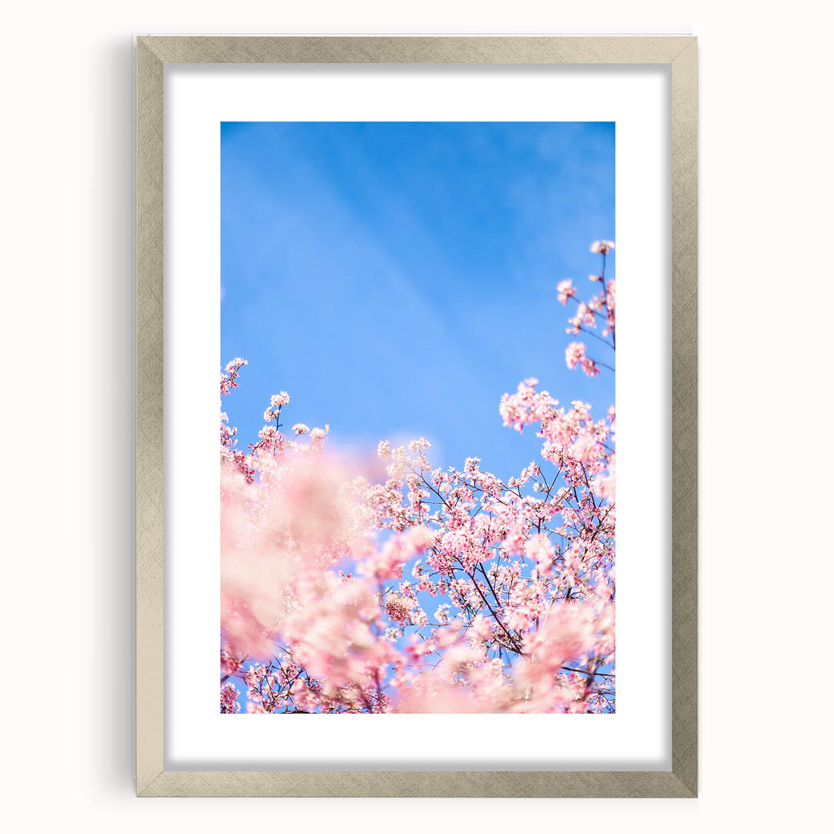 Textured abstract art print in soft pastel hues on a silver-framed mat, suitable for bedroom decor.