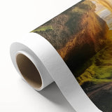 Rolled canvas artwork showcasing a vibrant landscape scene with intricate cave formations, wrapped securely in a protective cardboard tube for safe shipping and display.