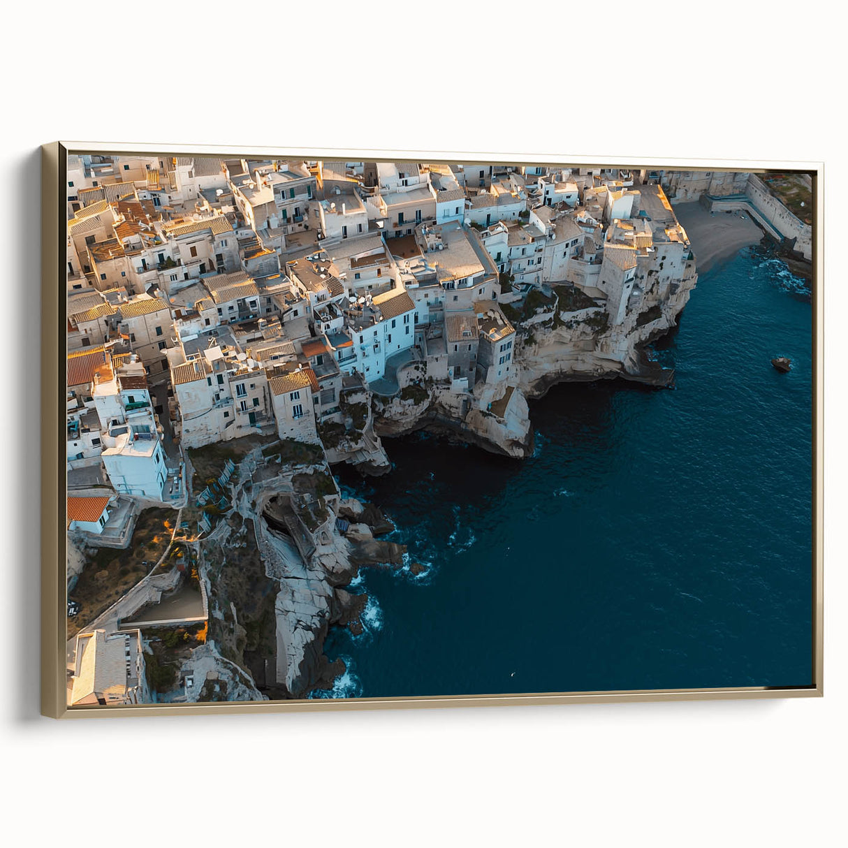 Framed canvas artwork depicting a stunning landscape of rugged cliffs under a vibrant sunset, featuring a gold frame that enhances its elegance. Perfect for home decor.