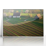 Framed acrylic artwork depicting a serene landscape scene, featuring lush green fields and a rustic barn, presented in a sleek white frame for modern decor.