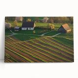 Stretched canvas artwork depicting a serene landscape scene with a rustic barn and vibrant greenery, perfect for enhancing home decor and creating a calming atmosphere.