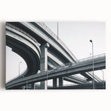 Stretched canvas artwork depicting a landscape scene of a bridge surrounded by lush greenery and a serene river, perfect for nature-inspired decor.