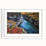 Framed landscape artwork depicting vibrant canyons in rich colors, featuring a white mat and a sleek black frame, ideal for home decor enhancement.