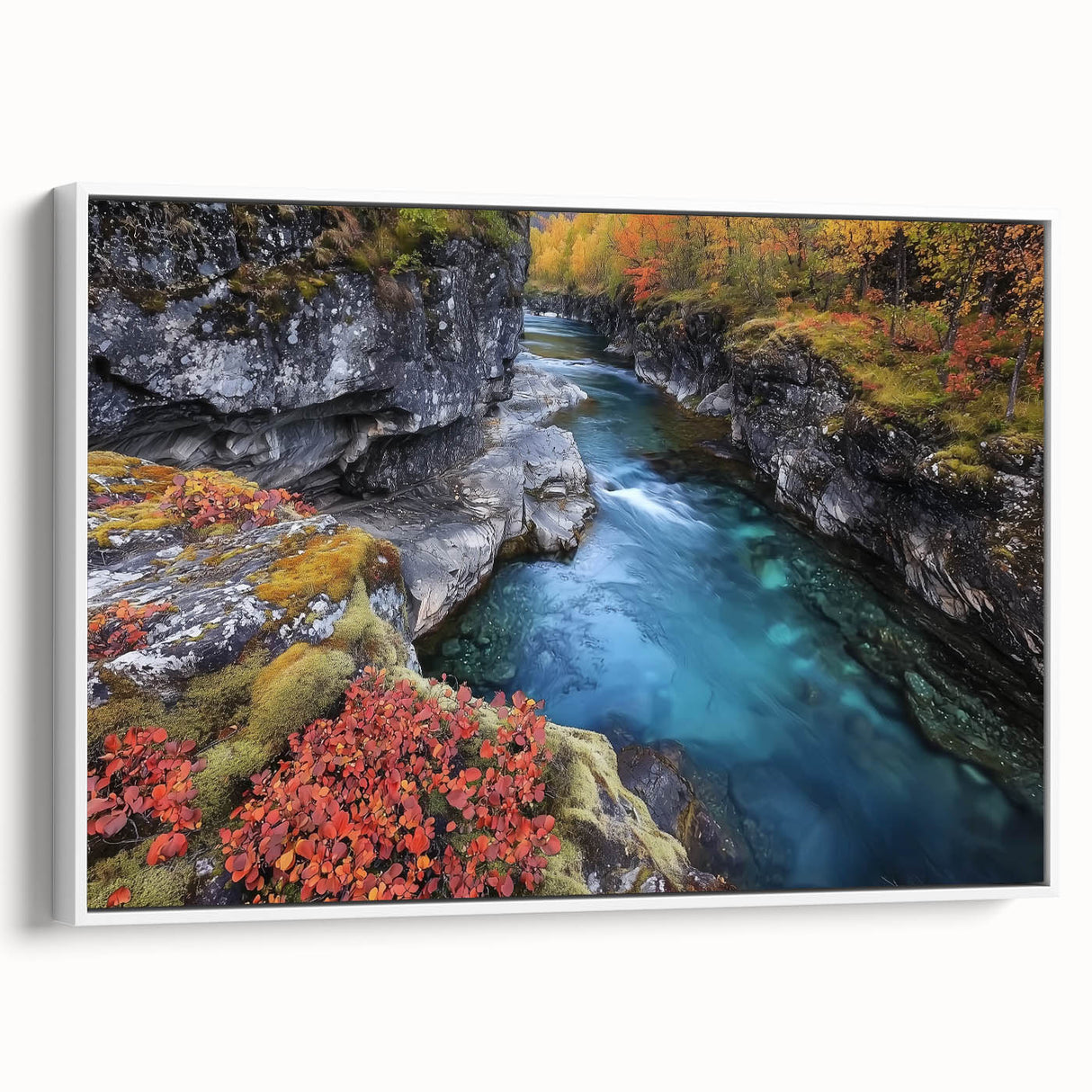 Framed landscape canvas art depicting a serene canyon scene with vibrant hues of orange and blue, showcased against a white frame, perfect for home decor.