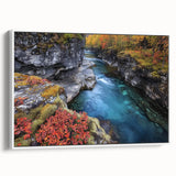 Framed landscape canvas art depicting a serene canyon scene with vibrant hues of orange and blue, showcased against a white frame, perfect for home decor.