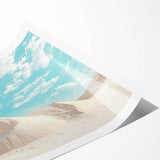 Desert landscape rolled print showcasing vibrant hues of orange and yellow with striking mountains, packaged securely in a protective cardboard tube for easy transport.